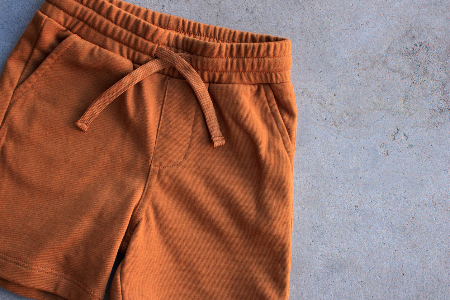 Brown shorts on a gray concrete surface