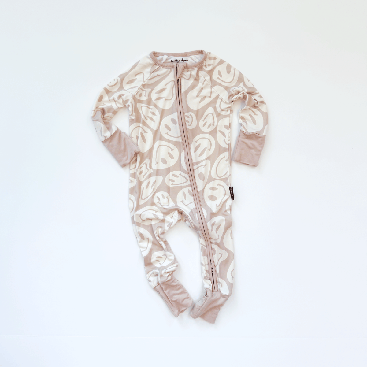 Baby onesie with happy face pattern on a white background