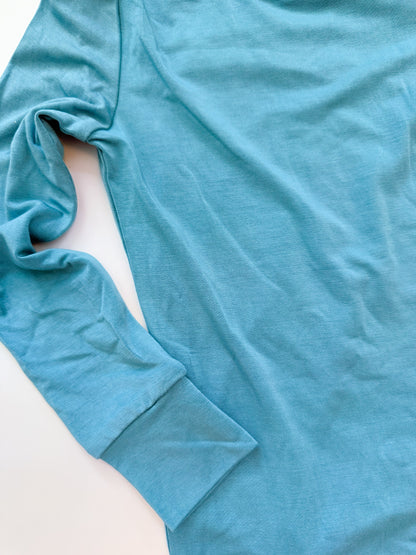 Close-up of a blue long-sleeve shirt on a light background