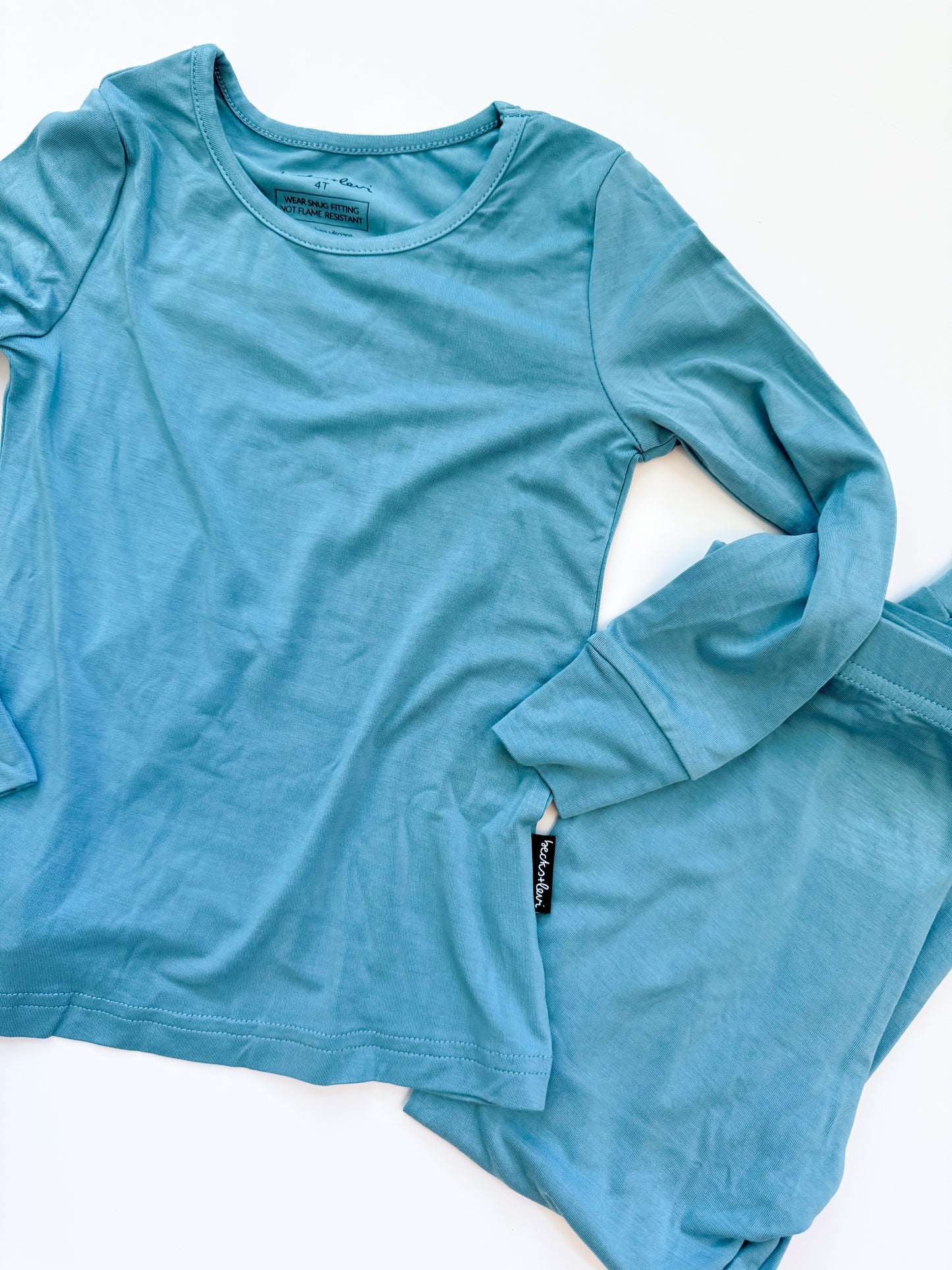 Blue long-sleeve shirt and pants set on a white background