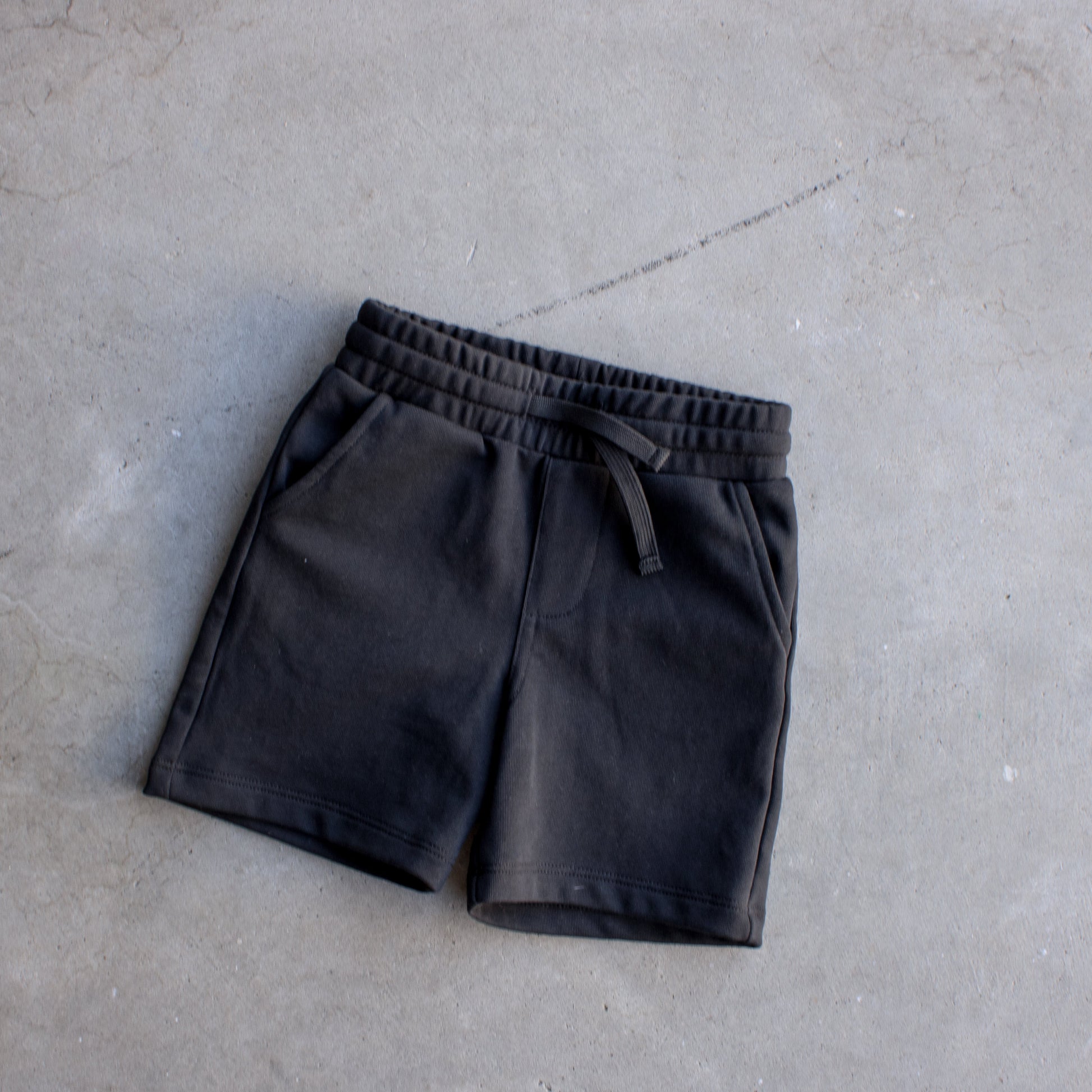 Black shorts on a concrete floor